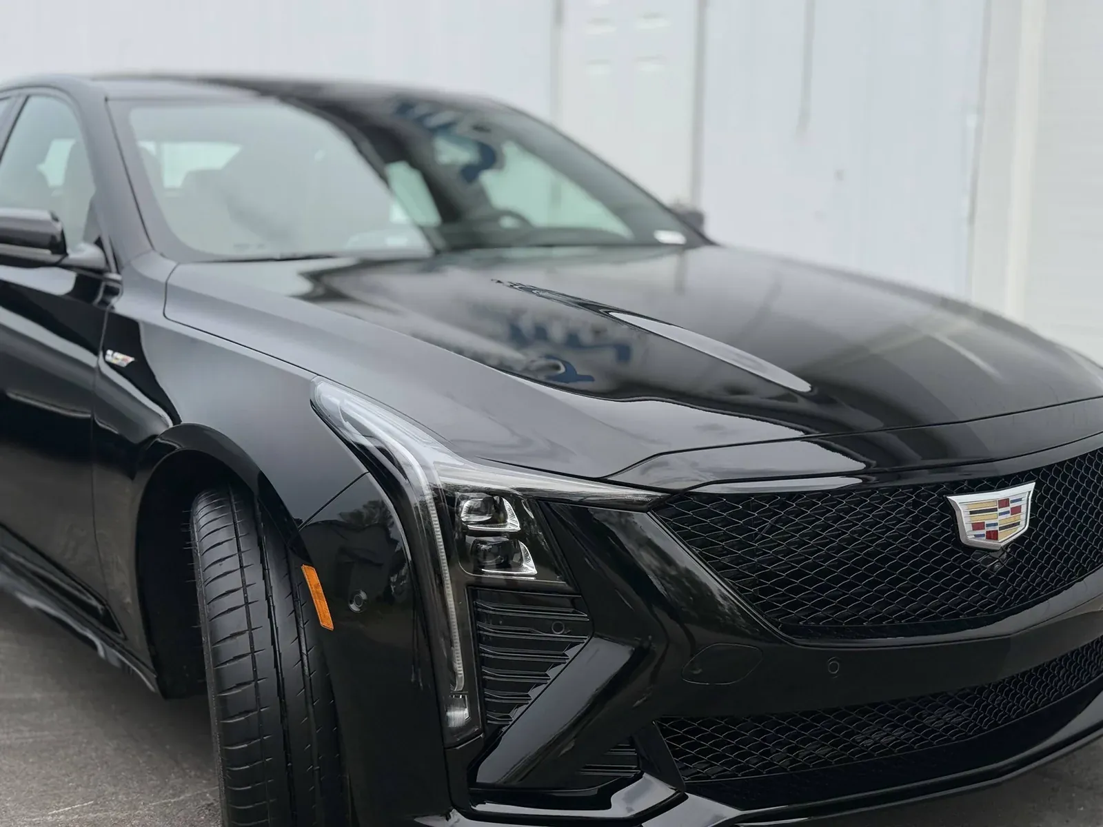 Black Cadillac sedan with a deep gloss finish after detailing