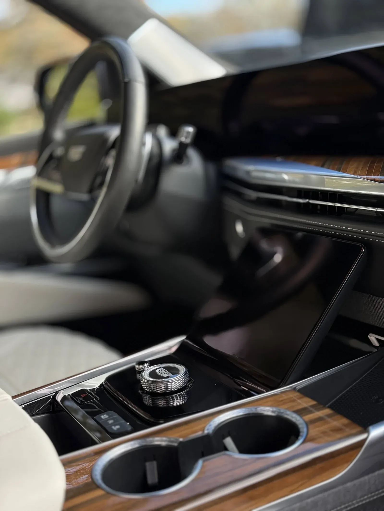 Cadillac center console, wood trim and cup holders after interior detailing